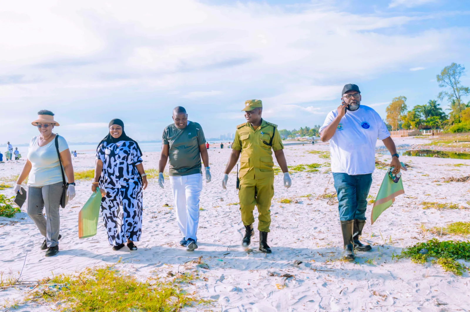 District Commissioner and local leaders during shoreline inspection at Mbezi Beach A